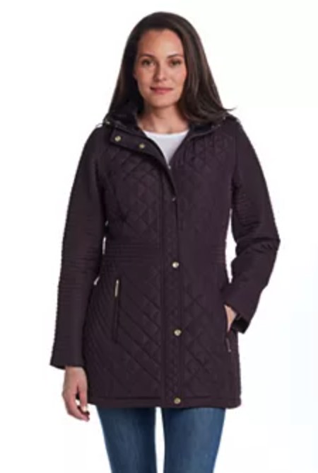 Woman wearing a plum purple diamond-quilted hooded jacket with gold snap buttons